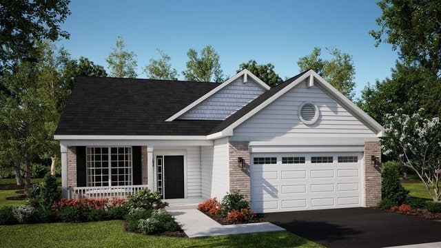 view of front of home with a garage and a front lawn