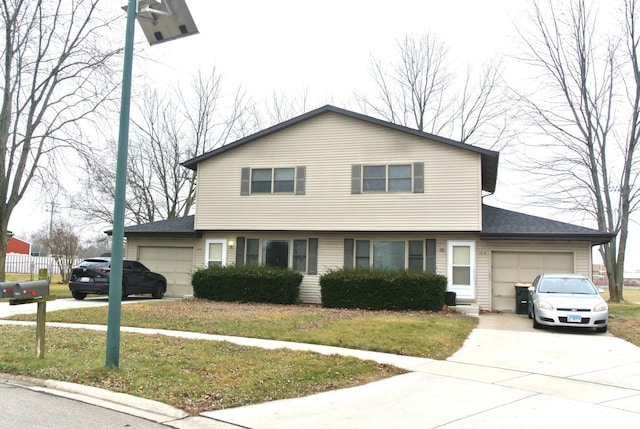 view of front of home with a front yard and a garage