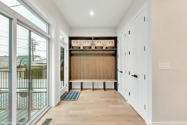 mudroom with light hardwood / wood-style flooring