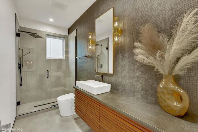 bathroom with an enclosed shower, vanity, and toilet