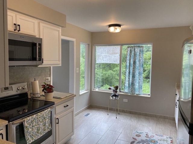 kitchen with white cabinetry and appliances with stainless steel finishes