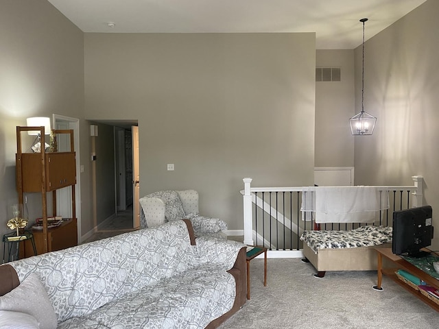 bedroom with carpet flooring and a towering ceiling