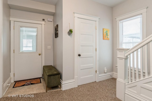 entryway featuring light colored carpet