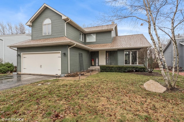 view of front of property featuring a front lawn and a garage