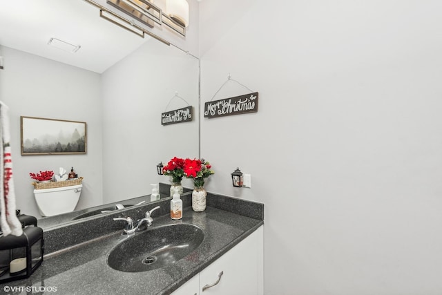 bathroom featuring vanity and toilet