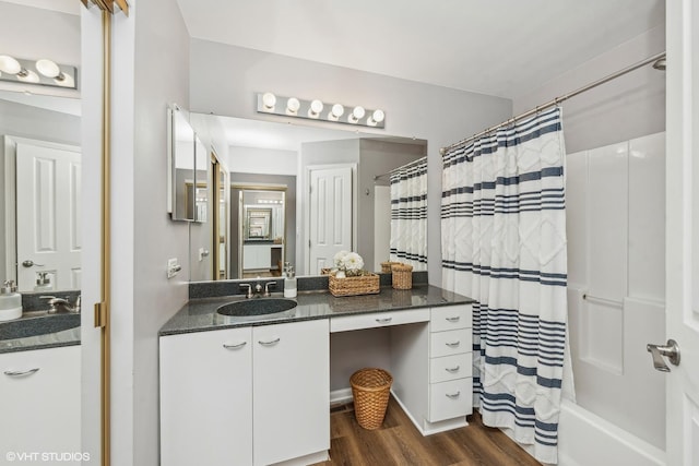 bathroom featuring vanity, wood-type flooring, and shower / bath combo