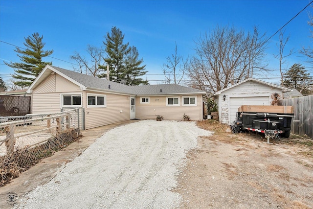 view of front of home with a garage and an outdoor structure