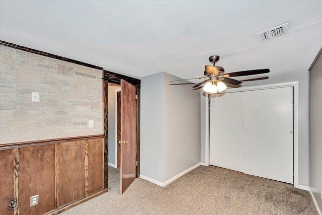 unfurnished bedroom with ceiling fan, a closet, and light colored carpet