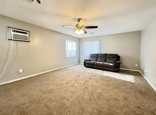 living room with a wall mounted air conditioner, carpet flooring, and ceiling fan