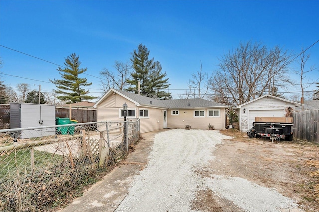 view of front of house with a garage and an outdoor structure