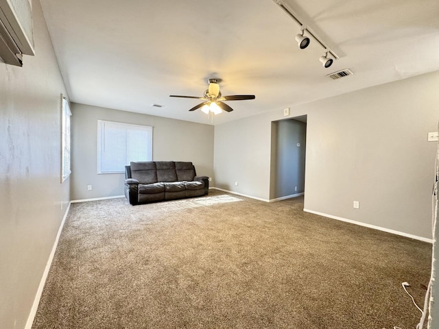 carpeted living room with ceiling fan and rail lighting