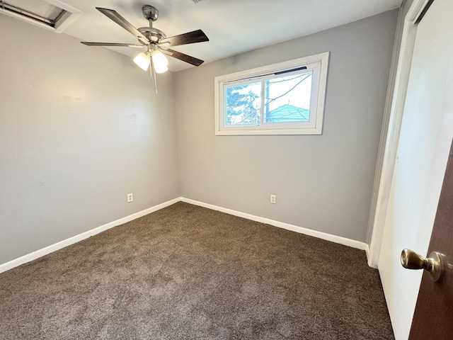 carpeted spare room featuring ceiling fan