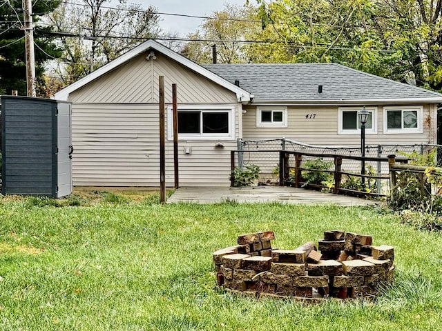 back of house with a lawn, an outdoor fire pit, and a patio