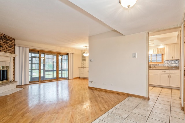 unfurnished living room featuring light tile patterned floors and a fireplace