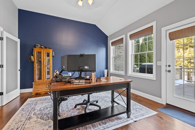 office area with dark hardwood / wood-style floors and vaulted ceiling