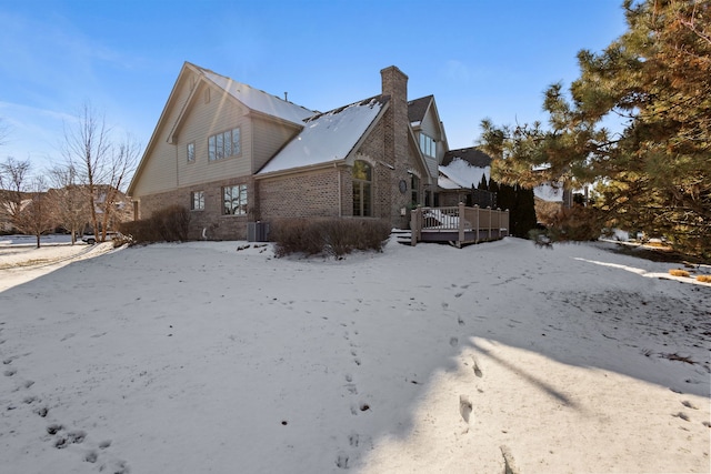 view of snow covered exterior featuring a deck