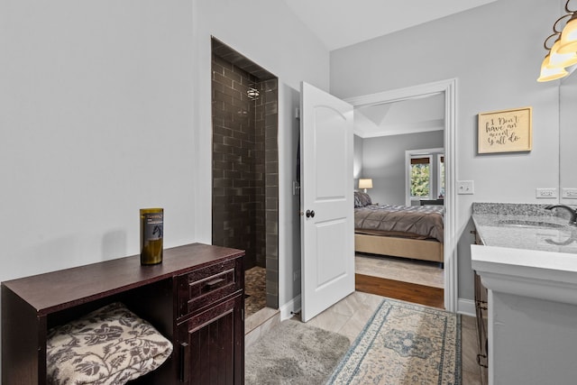 bathroom featuring vanity and a tile shower