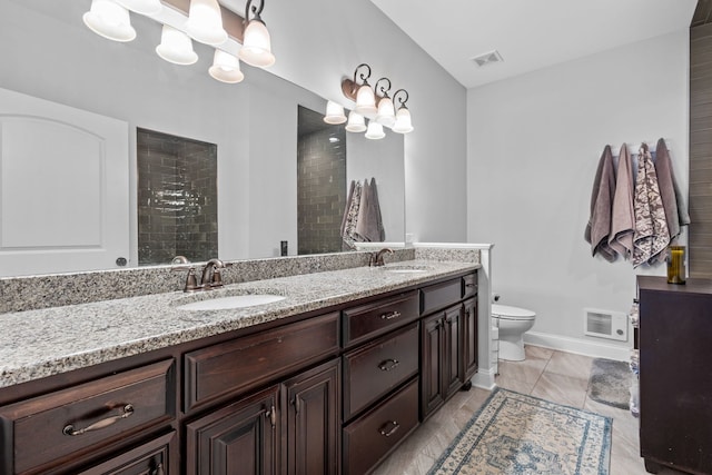 bathroom featuring toilet and vanity