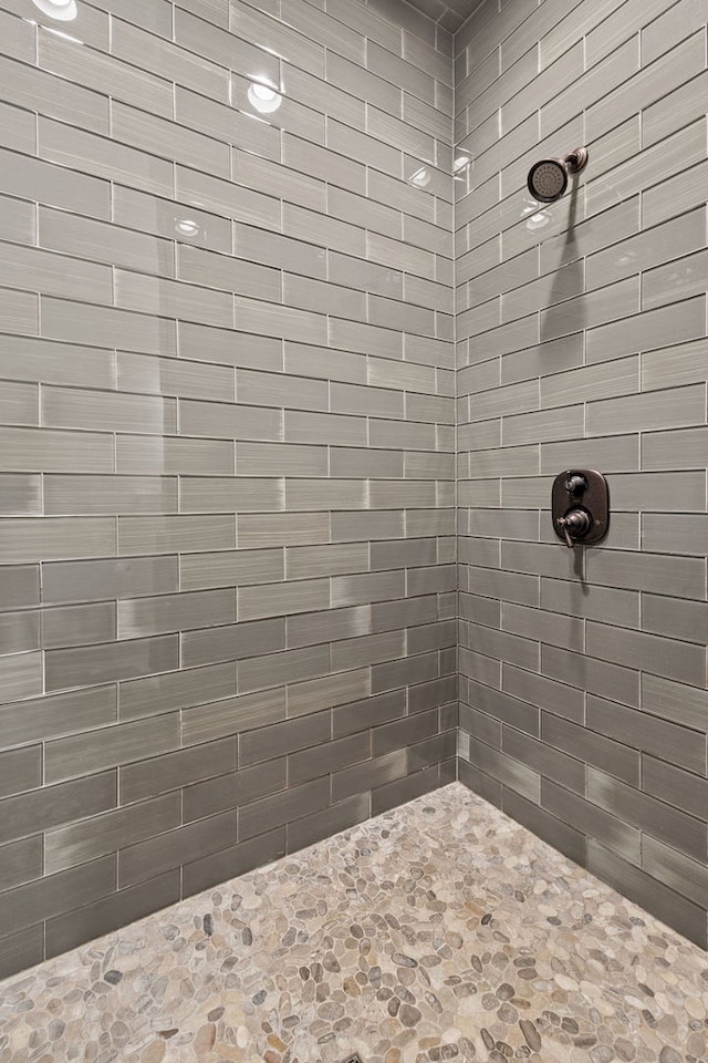 bathroom with a tile shower