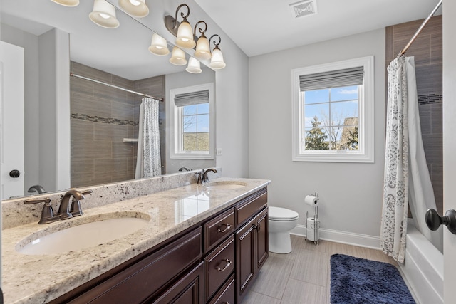 full bathroom with toilet, shower / tub combo, and vanity