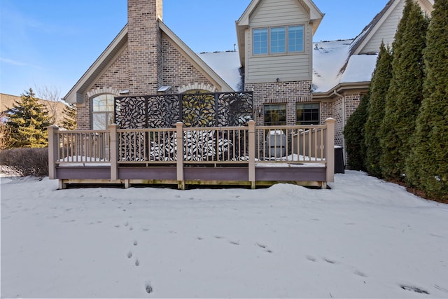 snow covered property featuring a wooden deck