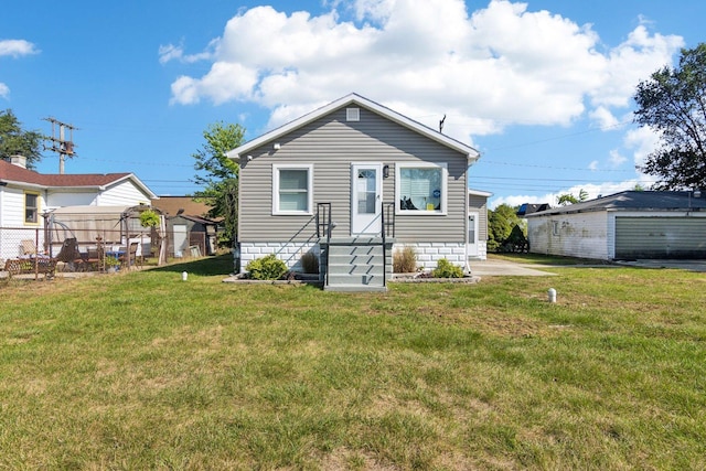 back of property with a lawn