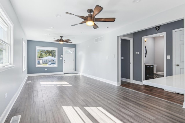 unfurnished living room featuring dark hardwood / wood-style floors