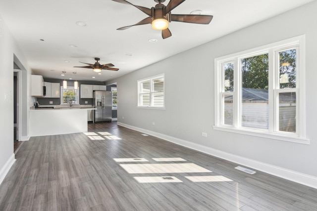 unfurnished living room with dark wood-type flooring