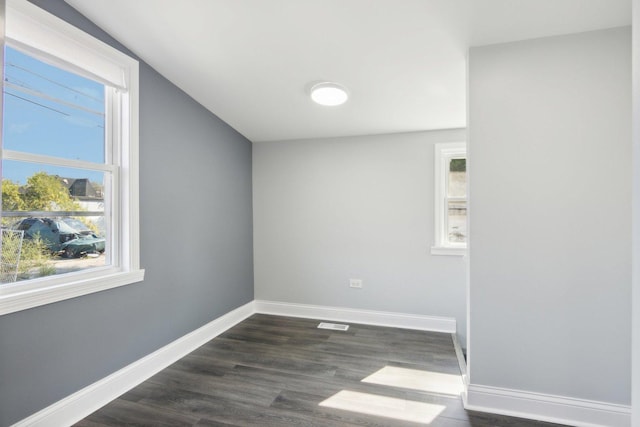 spare room with dark wood-type flooring