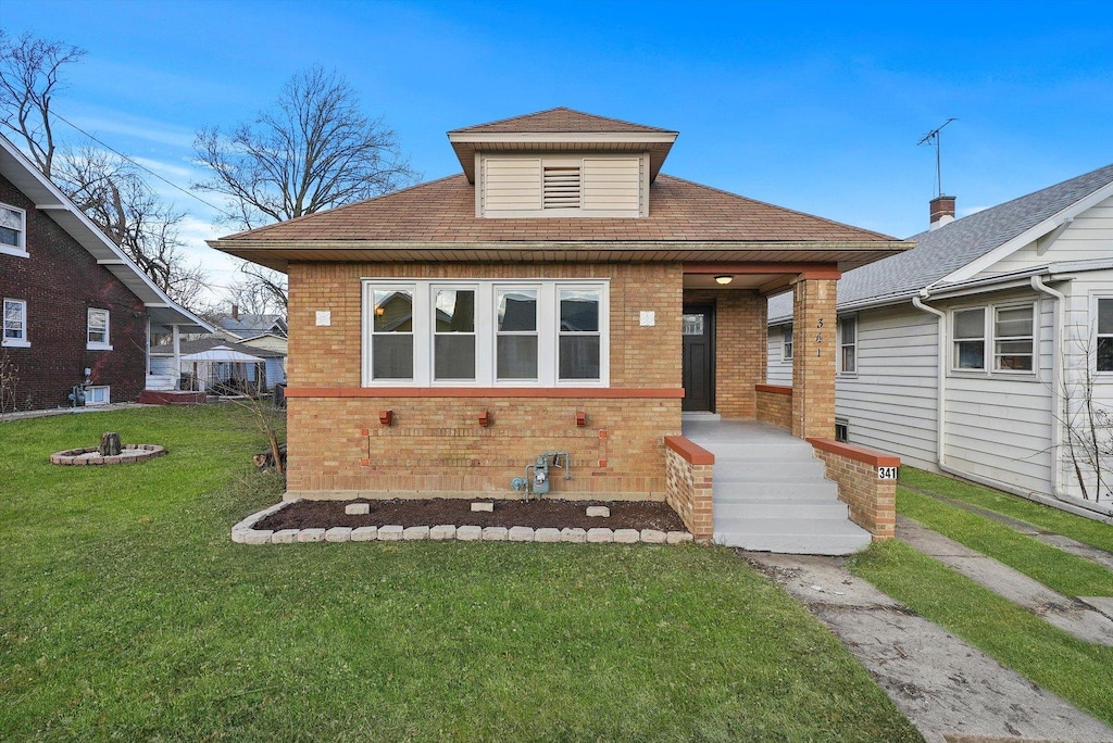 bungalow-style home featuring a front yard