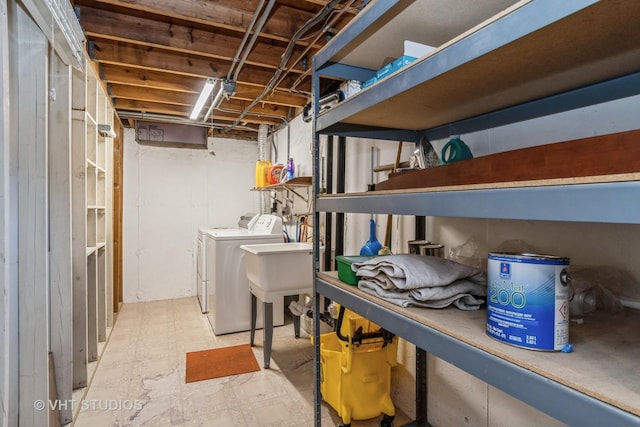 clothes washing area featuring sink and washing machine and dryer