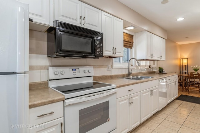 kitchen with white appliances, white cabinets, sink, backsplash, and light tile patterned floors