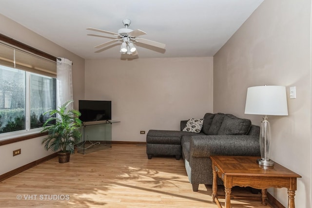 living room featuring ceiling fan and light wood-type flooring