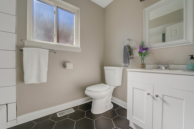 bathroom with tile patterned flooring, vanity, and toilet