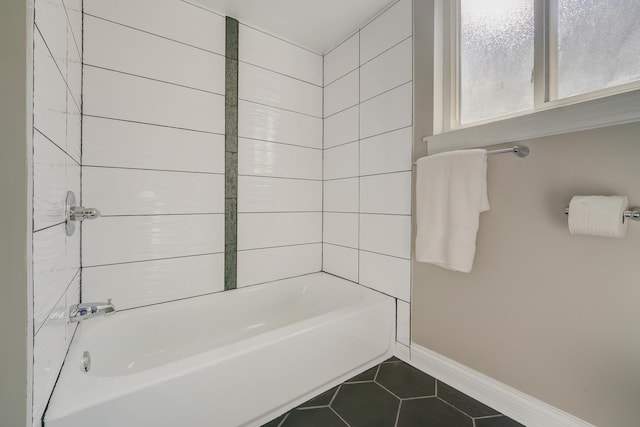 bathroom with tile patterned floors and tiled shower / bath