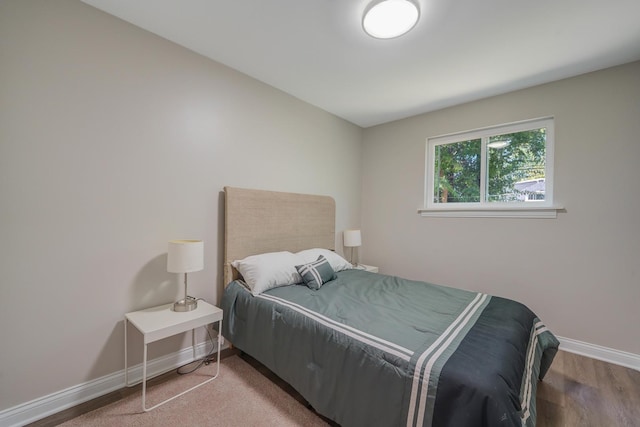 bedroom with hardwood / wood-style flooring