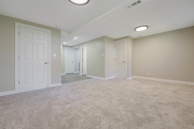 spare room featuring light carpet