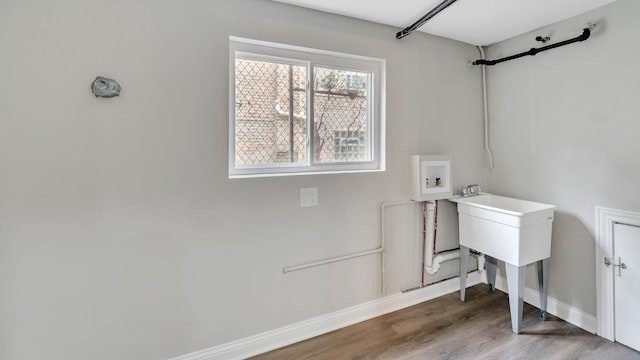 laundry room with wood-type flooring and hookup for a washing machine