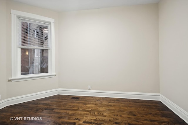 unfurnished room featuring dark hardwood / wood-style floors