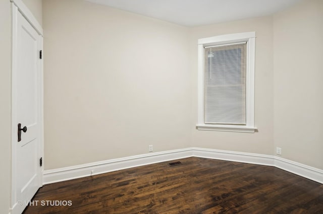 unfurnished room with dark hardwood / wood-style flooring