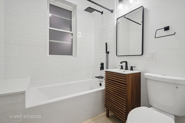 full bathroom featuring toilet, tiled shower / bath combo, and vanity