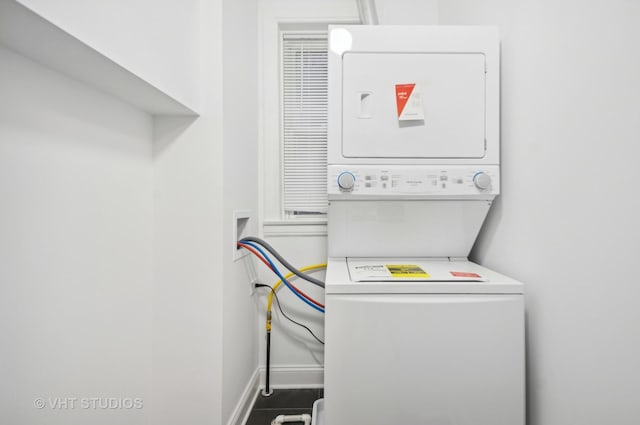 clothes washing area with stacked washer and clothes dryer