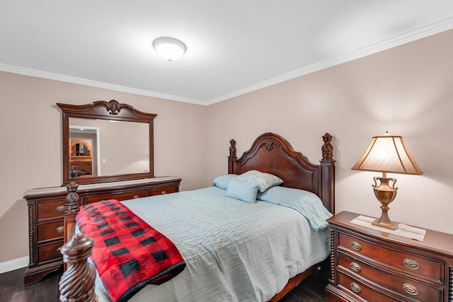 bedroom with dark wood-type flooring and ornamental molding