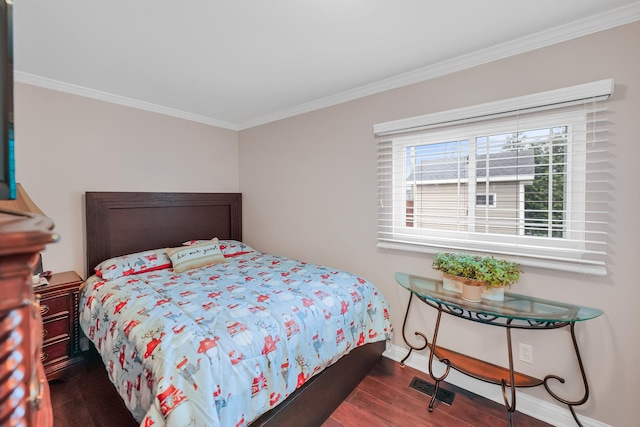 bedroom with dark hardwood / wood-style flooring and crown molding