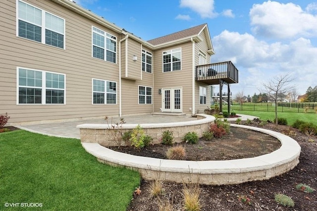 back of house featuring a patio area and a yard