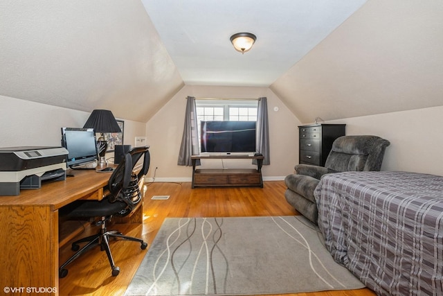 office featuring light hardwood / wood-style floors and vaulted ceiling