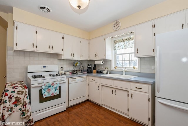 kitchen with sink, dark hardwood / wood-style flooring, white appliances, and white cabinets