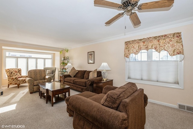 living room with ceiling fan, light colored carpet, and crown molding