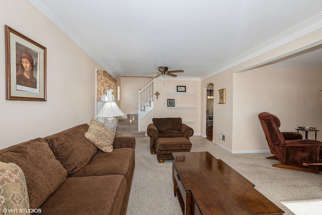 carpeted living room with ornamental molding and ceiling fan