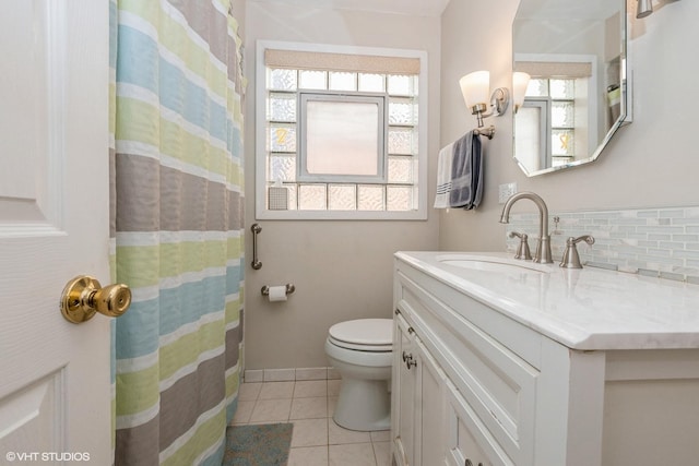 bathroom with toilet, decorative backsplash, tile patterned flooring, and vanity